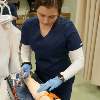 Nursing student checking a patient
